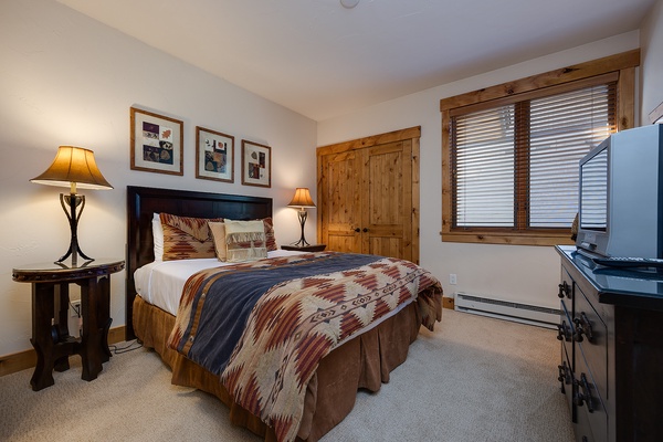 Sink into the plush bedding and rustic warmth of your private retreat, where soft lighting and mountain views promise restful nights after days of adventure.