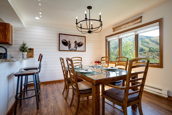 Gather around this inviting dining table where shared meals feel even more special. Bright mountain views frame every conversation, and rustic farmhouse charm creates a warm, welcoming atmosphere for your group.