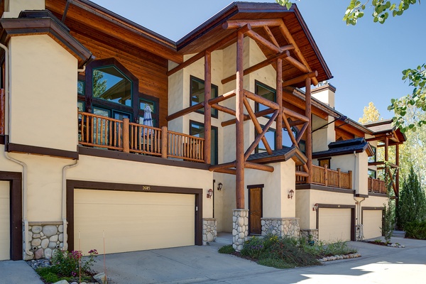 A stunning mountain-style property with exposed timber beams, spacious balconies, and stone accents that blend modern comfort with alpine charm in a serene natural setting.