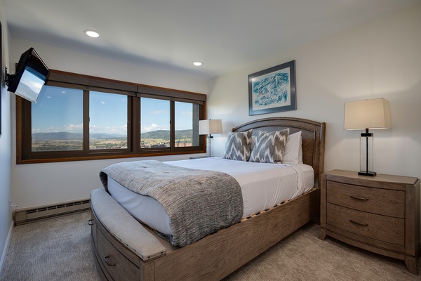 Drift off in your serene bedroom, where sweeping mountain views frame the horizon and cozy bedding invites peaceful sleep. Wake to natural light and breathtaking scenery.