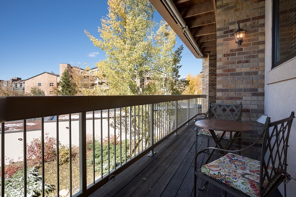 Picture yourself sipping morning coffee on your private balcony, surrounded by golden autumn foliage and fresh air. This cozy outdoor retreat offers peaceful neighborhood views and a perfect spot to unwind after exploring.