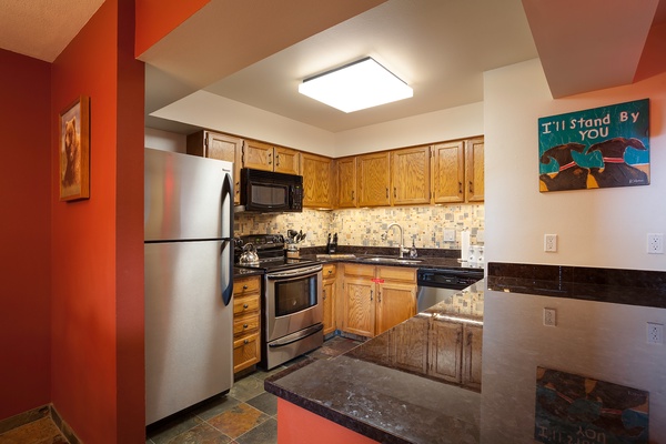 Your fully-equipped kitchen has everything you need to prepare your favorite meals, with warm wood cabinetry, modern appliances, and plenty of counter space for easy cooking.