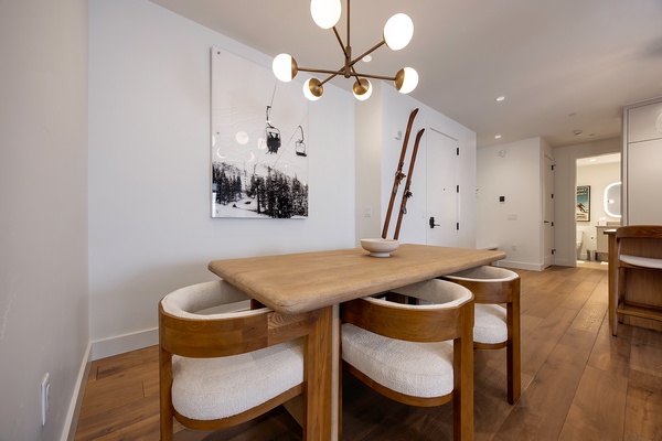 Gather around this stylish dining space where vintage skis and modern elegance meet, creating the perfect spot for sharing meals and mountain memories with your group.