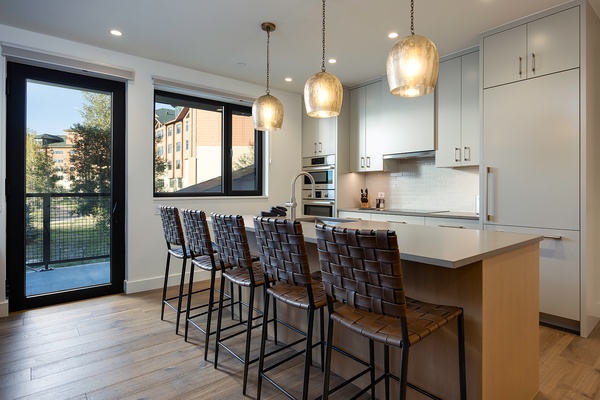 Gather with friends at your sleek kitchen island, where modern design meets comfort. Stunning pendant lighting sets the mood as you enjoy bright, airy spaces flooded with natural light from generous windows and easy balcony access.