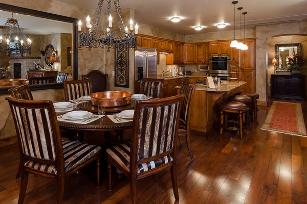 Your elegant dining space and fully equipped kitchen invite memorable meals together. Warm wood tones, custom cabinetry, and gleaming appliances blend comfort with style—your home away from home.