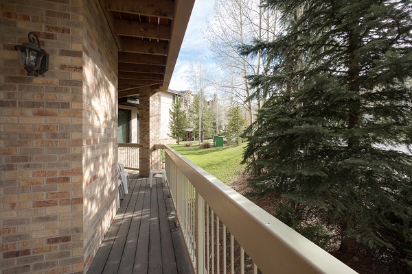The property features a peaceful setting surrounded by mature evergreens and natural landscaping, offering a serene backdrop for your mountain getaway.
