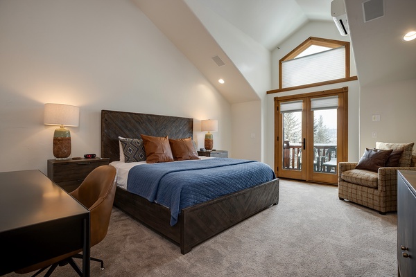 Wake up to snowy treetops framed by the door to your private balcony. This spacious retreat features vaulted ceilings, a cozy reading chair, and a plush king bed calling your name.