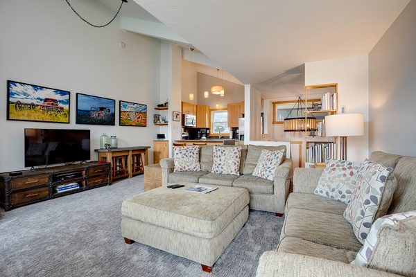 Sink into plush sofas and unwind in your open-concept living space, where natural light, warm wood accents, and modern comforts create the perfect retreat after a day of adventure.