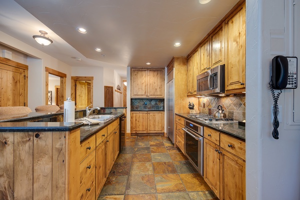 Step into your fully equipped kitchen with granite countertops, modern appliances, and a spacious layout perfect for preparing memorable meals during your stay.
