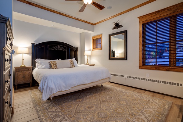 Sink into your plush bed with crisp linens and rustic mountain charm. Wood beams and warm lighting create a cozy retreat for restful nights after your adventures.