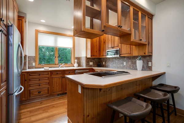 Prepare home-cooked meals in your spacious kitchen with rich wood cabinetry, modern appliances, and an inviting island where you can gather with loved ones.