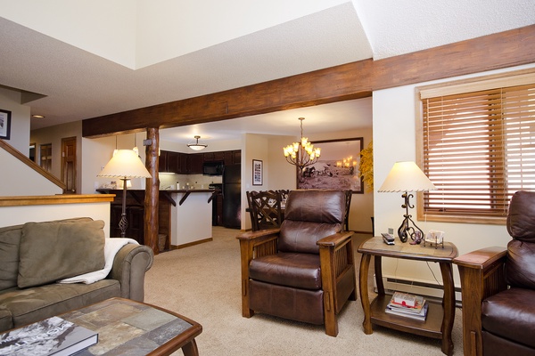 Unwind in your cozy mountain retreat with leather recliners, warm wood beams, and a fully-equipped kitchen ready for your stay.