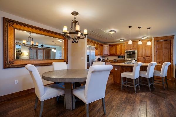 Gather around the spacious dining area and fully equipped kitchen, where warm wood tones and elegant finishes create the perfect setting for your group meals and morning coffee.