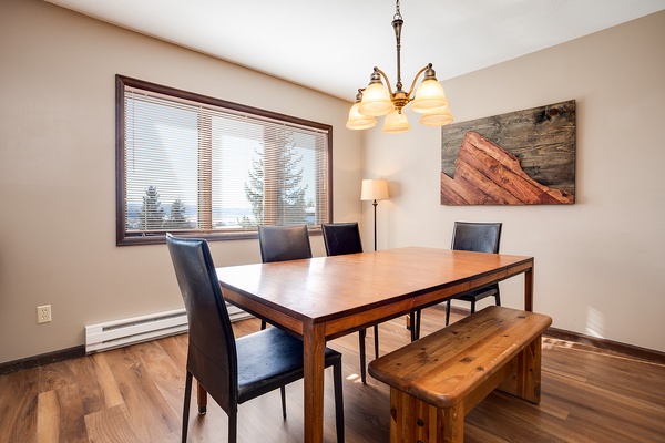 Gather around the dining table for meals bathed in natural light, with rustic mountain-inspired decor setting a cozy, inviting tone for your group.