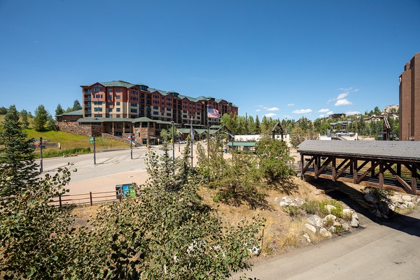 This property sits in a scenic mountain village setting surrounded by evergreen forests and winding pathways, perfect for a peaceful alpine getaway.