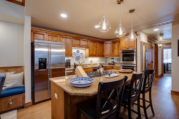 Gather around this spacious island with modern appliances at your fingertips. Enjoy warm wood cabinetry, granite countertops, and everything you need to whip up delicious meals together.