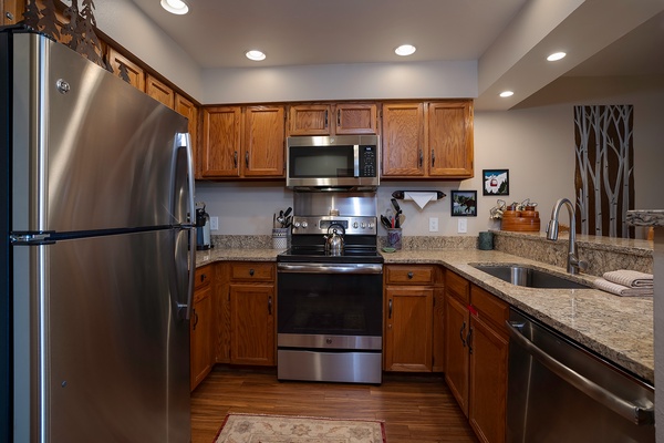 Your fully equipped kitchen features stainless steel appliances, granite countertops, and warm wood cabinetry, making it easy to prepare meals just the way you like them.