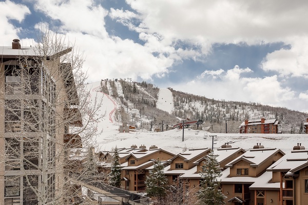 Ski-in/ski-out mountain village nestled beneath pristine slopes, offering direct access to winter adventures amid snow-covered peaks and alpine charm.