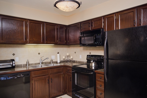 Your fully equipped kitchen features rich wood cabinetry, granite countertops, and all the appliances you need to prepare delicious home-cooked meals during your stay.