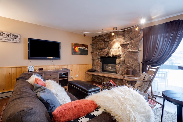 Curl up on the plush sofa with cozy throws and sink into your perfect mountain retreat, where a rustic stone fireplace adds warmth and charm to your relaxing evenings together.