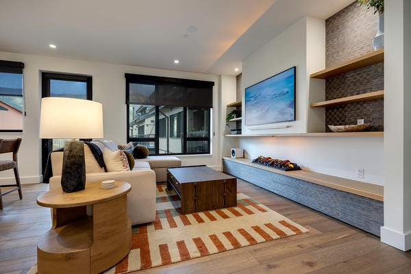 Unwind in your contemporary living space, where natural light pours through expansive windows and thoughtful design meets modern comfort, perfect for relaxing evenings.