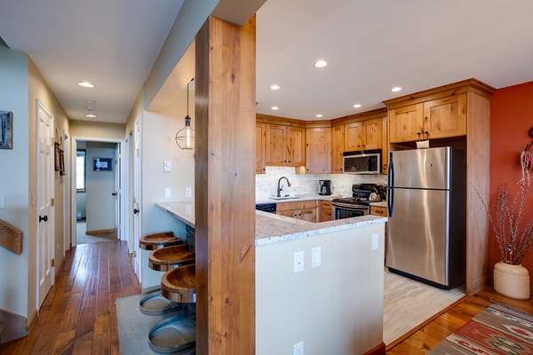 Your bright, fully equipped kitchen features stainless steel appliances, elegant granite countertops, and a breakfast bar perfect for casual dining or morning coffee with loved ones.