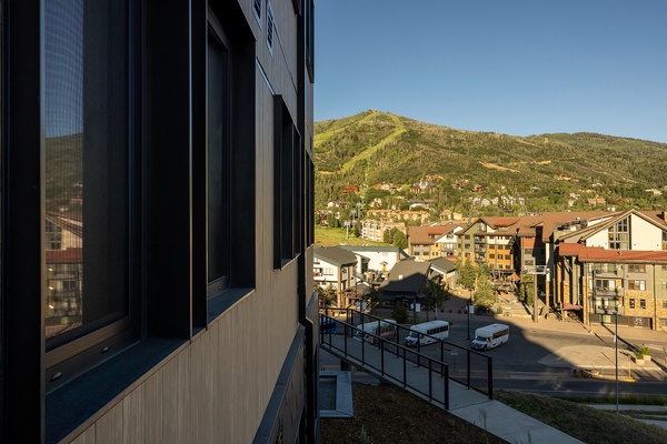 Your private balcony frames sweeping mountain views and the vibrant town below. Step outside and breathe in the alpine air as you take in the scenic slopes and charming rooftops.