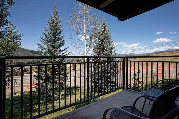 A peaceful mountain setting with tree-lined streets and open land, offering a quiet retreat near natural surroundings.