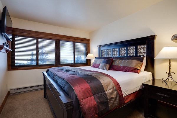 Sink into plush bedding and wake to soft natural light filtering through your private window. Your restful retreat features elegant furniture and warm bedside lamps creating the perfect atmosphere for relaxation.