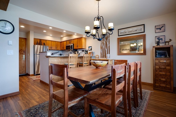 Gather around this handcrafted dining table where your group can share meals and make memories. The open layout flows into a fully equipped kitchen, perfect for cooking together and enjoying your mountain getaway.