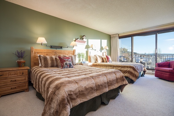 Sink into plush beds wrapped in soft faux fur as natural light pours through floor-to-ceiling windows, framing lake views that greet you each morning in your peaceful retreat.