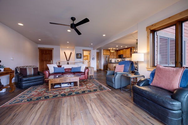Unwind in your spacious living room with vaulted ceilings, plush leather seating, and an open layout that flows into a fully-equipped kitchen—perfect for relaxing after a day of exploring.