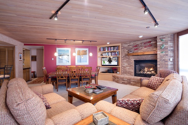 Unwind in your spacious living area with cozy seating, a warm fireplace, and open layout that invites conversation and relaxation after a day of adventure.