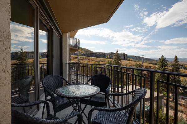 Enjoy morning coffee on your private balcony overlooking rolling hills and mountain vistas—a peaceful spot to plan adventures or simply soak in the tranquil surroundings.