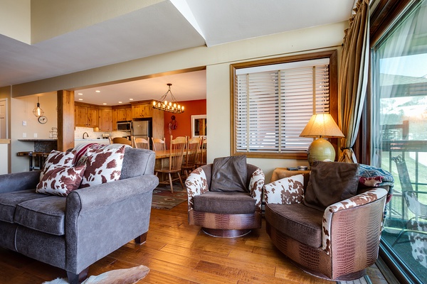 Sink into cozy seating with rustic charm as you enjoy an open floor plan connecting your living room, dining area, and fully equipped kitchen—perfect for gathering together.