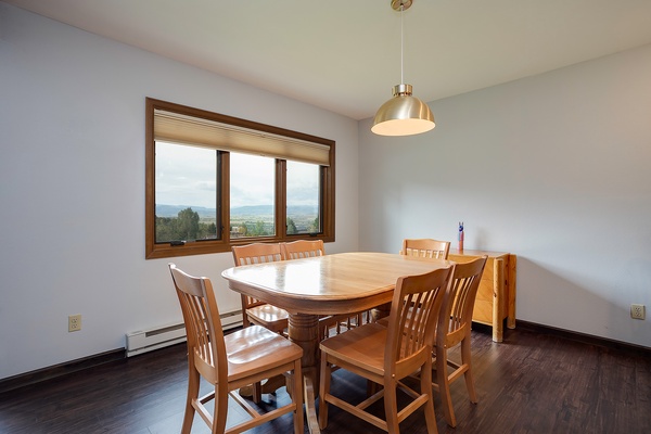 Gather around this inviting table and enjoy meals with stunning mountain views as your backdrop. The bright, airy space creates the perfect setting for memorable conversations.