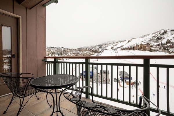 A private balcony overlooks pristine ski slopes and snow-dusted mountain terrain, offering direct views of winter adventures awaiting just beyond your cozy retreat.