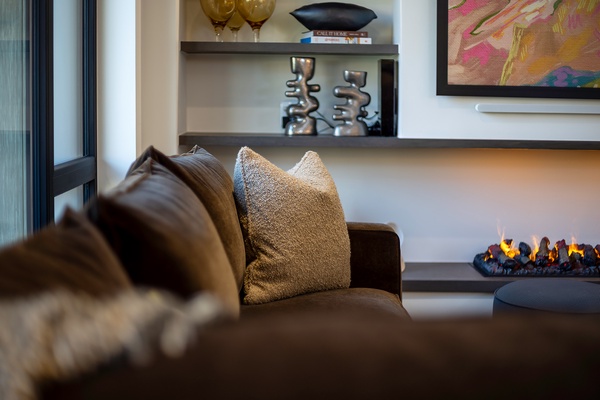 Sink into plush seating beside a warming fireplace and admire the curated art and sculpture that make this space feel like your own stylish retreat.