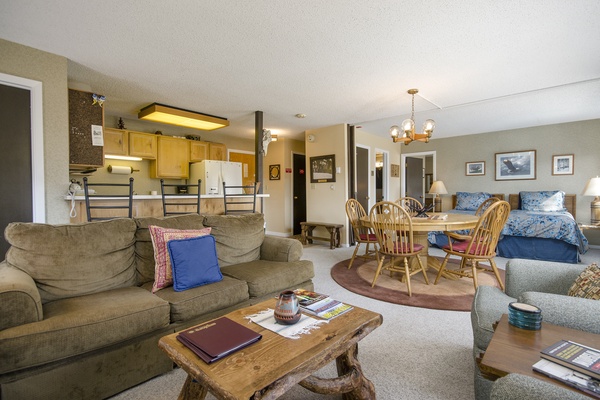 Step into your cozy open-concept retreat where rustic charm meets home comfort. Relax on plush sofas, gather around the dining table, and unwind in your inviting sleeping area—all seamlessly connected for easy living.