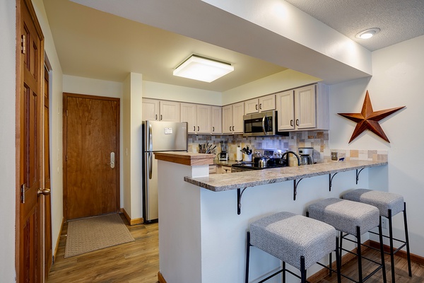 Your fully equipped kitchen features stainless steel appliances, granite countertops, and a breakfast bar—perfect for cooking meals and sharing conversation over morning coffee.