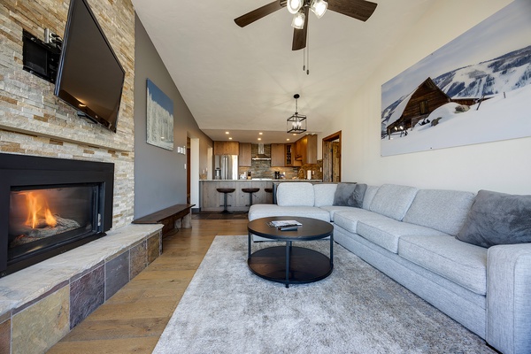 Sink into plush sofas by the glowing fireplace, where vaulted ceilings and mountain artwork set the scene for cozy evenings after your day on the slopes.