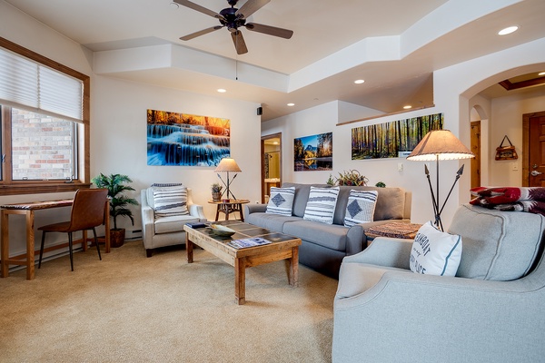 Settle into your spacious living room with plush seating, nature-inspired artwork, and soft lighting creating a welcoming retreat after your mountain adventures.
