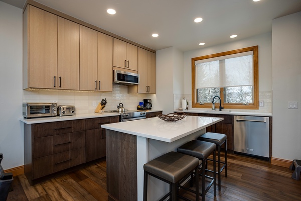 Your fully equipped kitchen invites home-cooked meals with modern appliances, generous counter space, and cozy island seating where you can gather over morning coffee or evening wine.