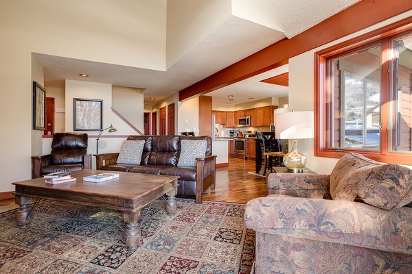Unwind in your spacious open living area, where rich wood tones, comfortable seating, and warm natural light create the perfect retreat after a day of adventure.