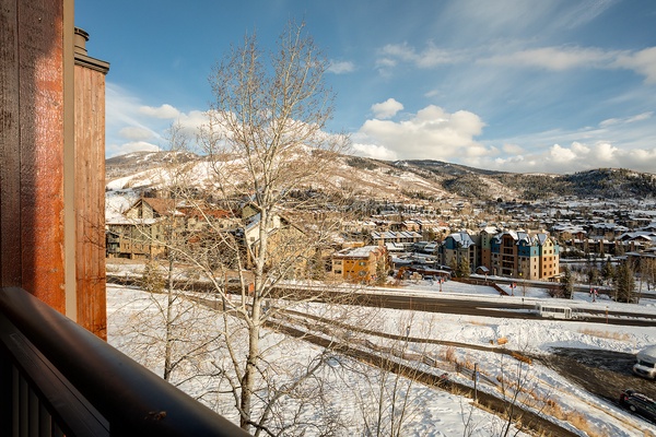 Sweeping winter mountain vistas frame this charming alpine village, where snow-dusted slopes meet a picturesque ski town below, offering a serene seasonal backdrop to the property's location.