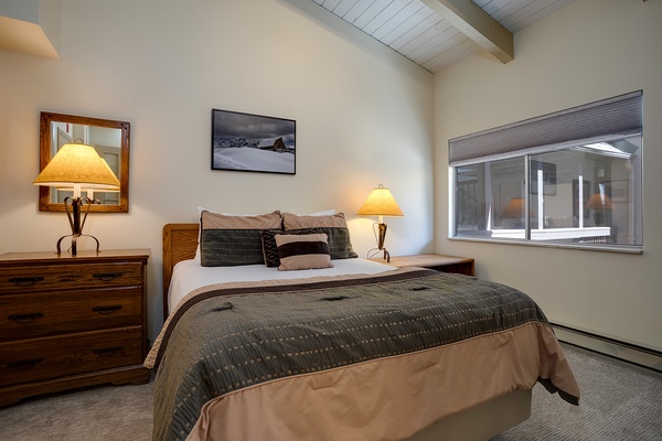 Sink into your plush bed as warm lamplight glows, creating a peaceful retreat where you can unwind under exposed beam ceilings after a day exploring the mountains.