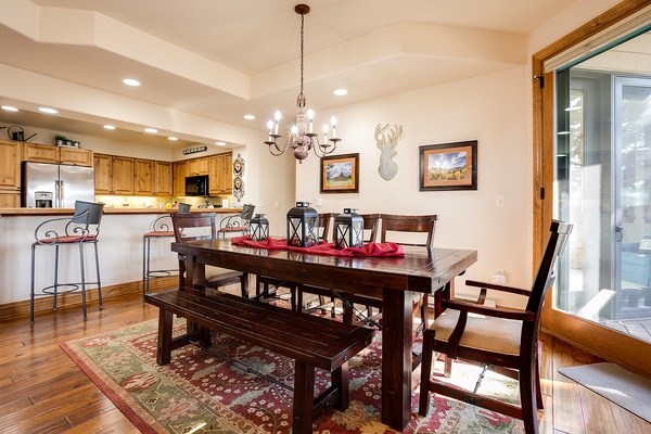 Gather around the spacious dining table, perfect for family meals and game nights, or unwind at the kitchen bar as warm lighting and mountain-inspired decor create a welcoming retreat for your stay.