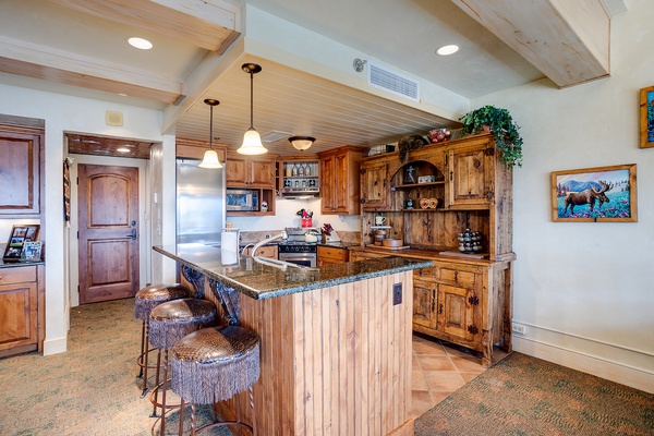 Step into your beautifully crafted kitchen with rich wood cabinetry, granite countertops, and a charming island perfect for morning coffee or evening meals.