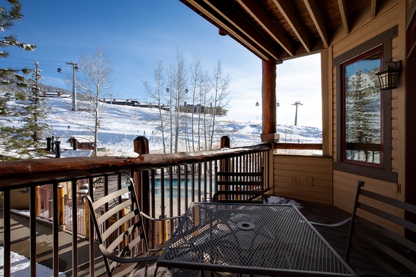 A mountain resort located near ski slopes with gondola access and bare winter trees surrounding the property.