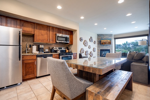 Your open-concept kitchen and living space welcomes you with warm wood tones, granite counters, stainless appliances, and scenic views perfect for relaxing after exploring the area.
